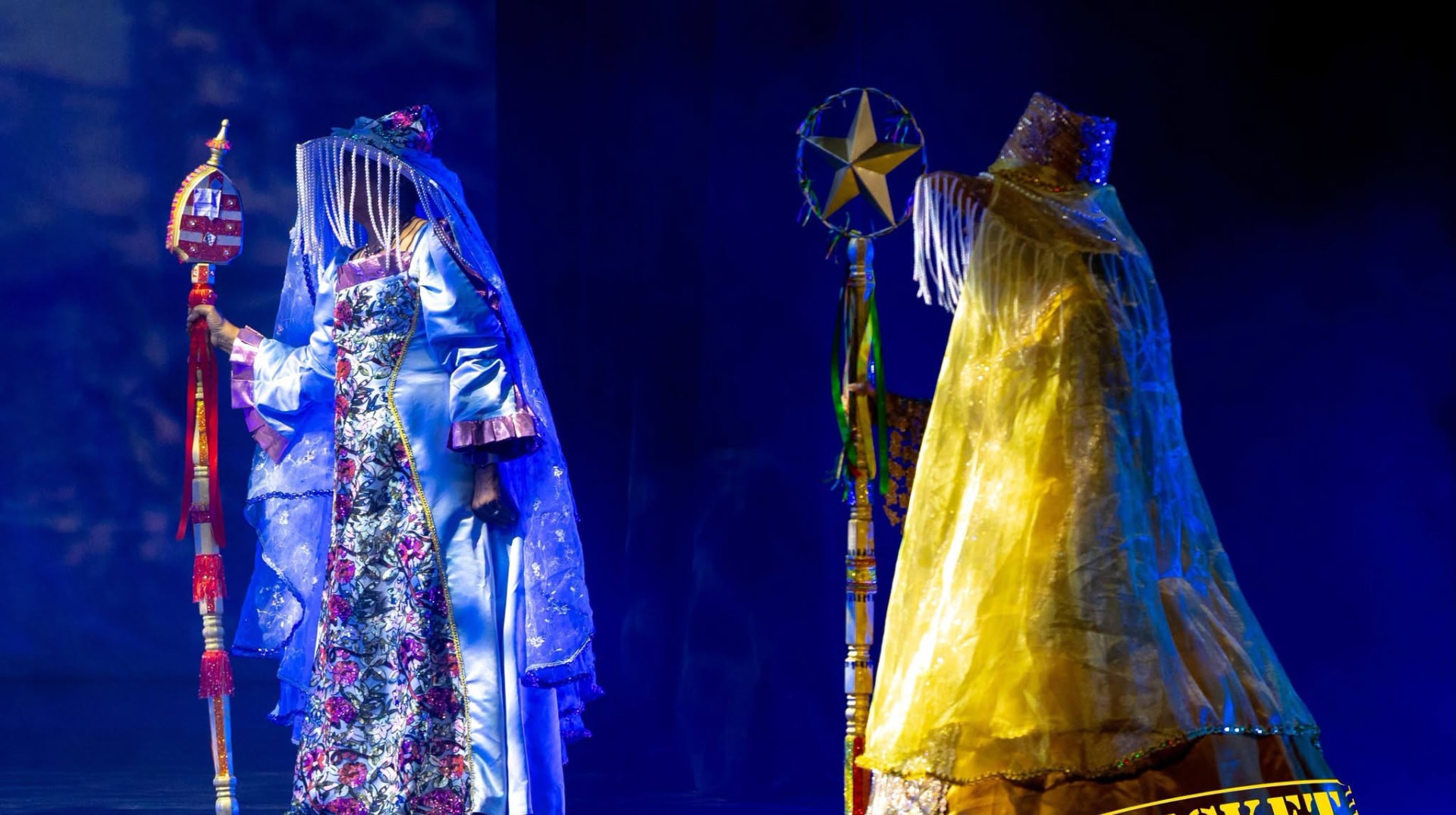Performers in luminous costume on stage