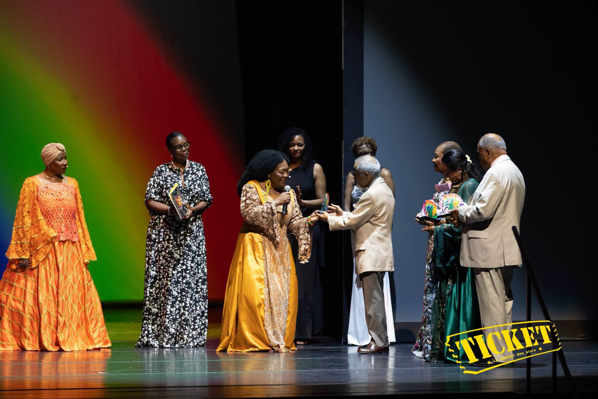 Honorees receiving awards on stage under Haitian flag colors