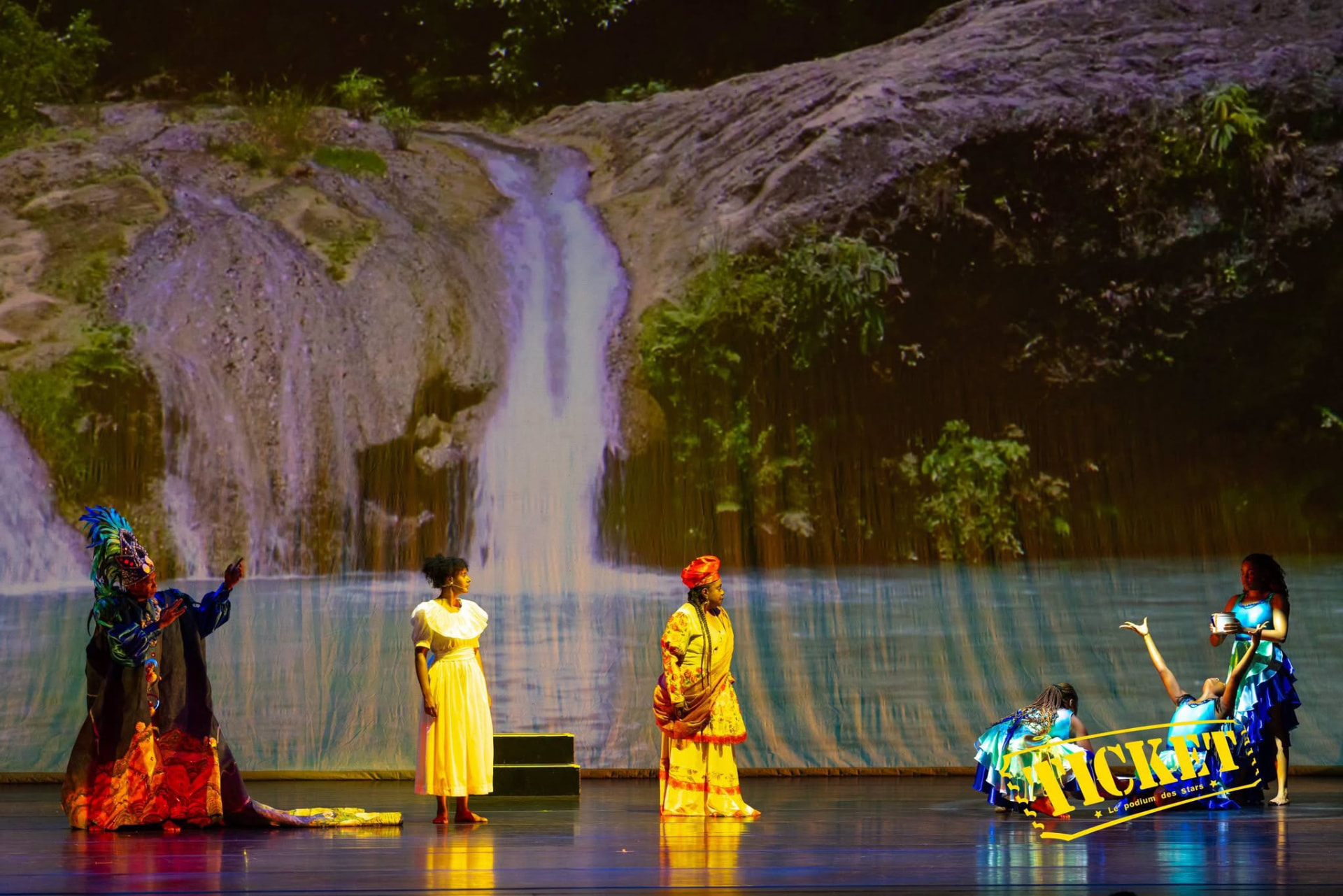 Performers before a projected waterfall on the Arsht Center stage